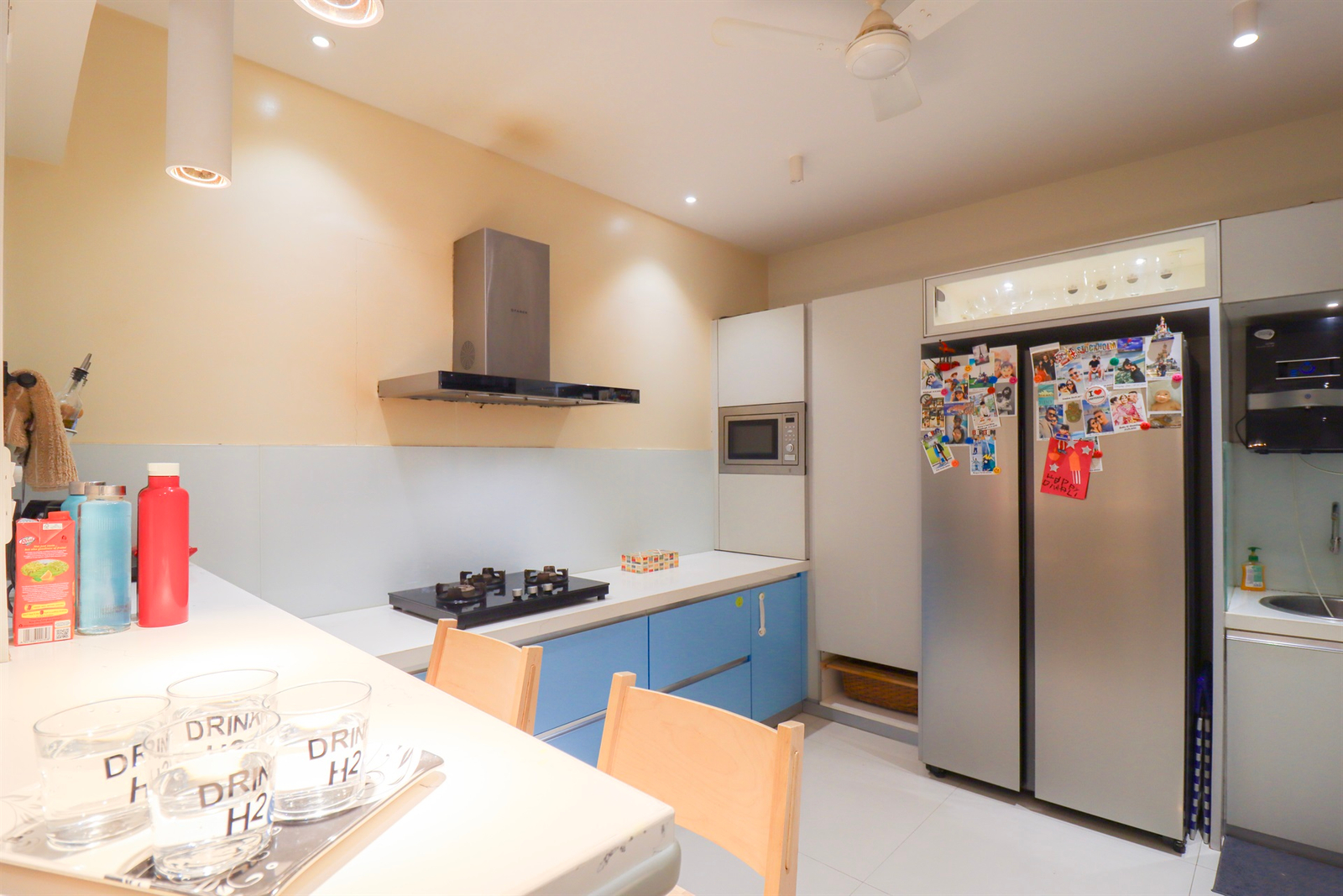 a modern kitchen design with a refrigerator and a table