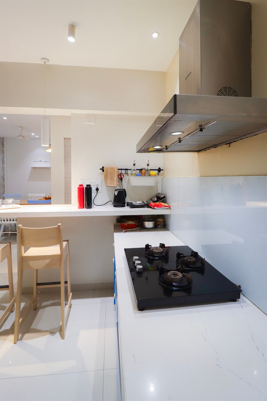 a kitchen with a stove and chairs